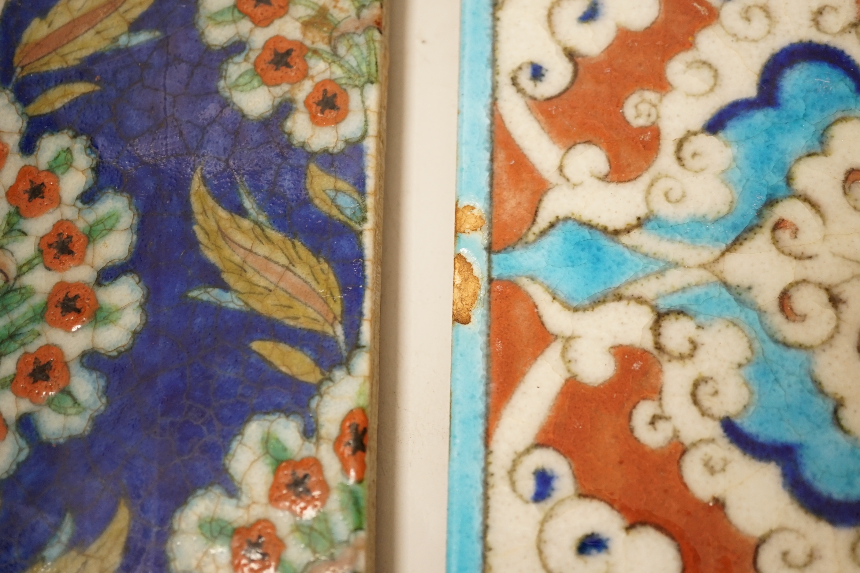 Two small Turkish Iznik pottery tiles, decorated with stylised flowers, each 24cm x 16cm